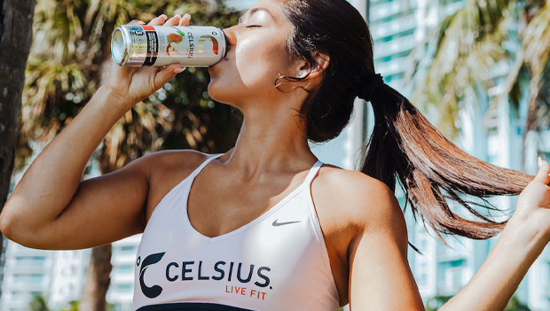 A woman drinking a can of celesus light.