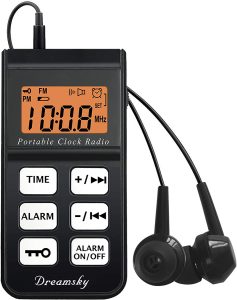 Portable clock radio with earphones.