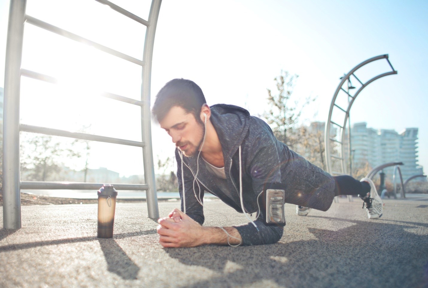 A man is doing push ups in the park.