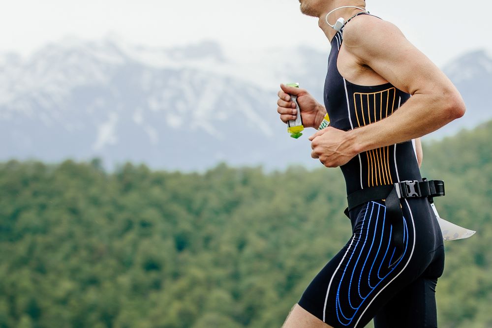 A man jogging in front of mountains.