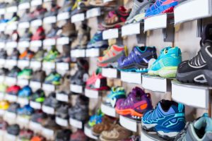 Many different types of shoes are on display in a store.