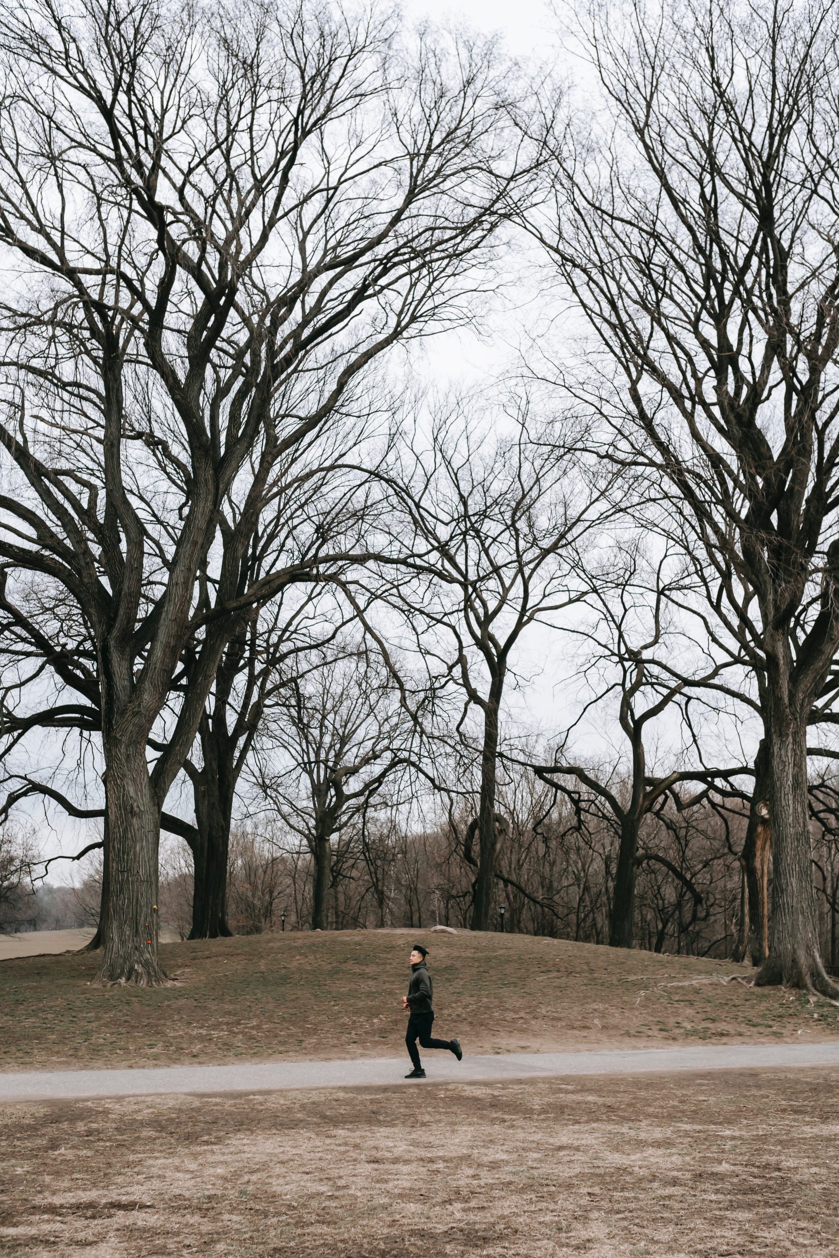 A person running through a park with no trees.