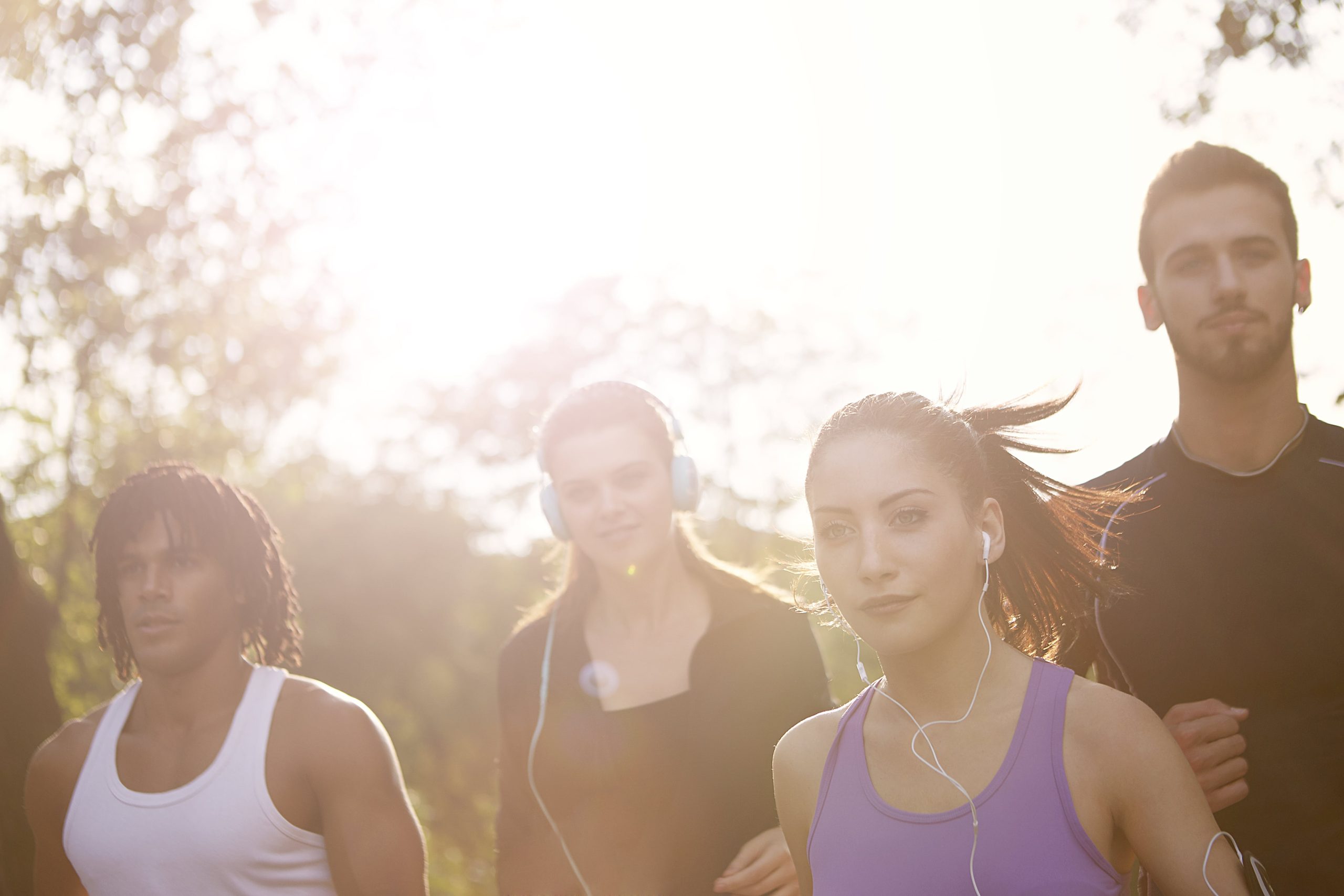 A group of people jogging in a park.