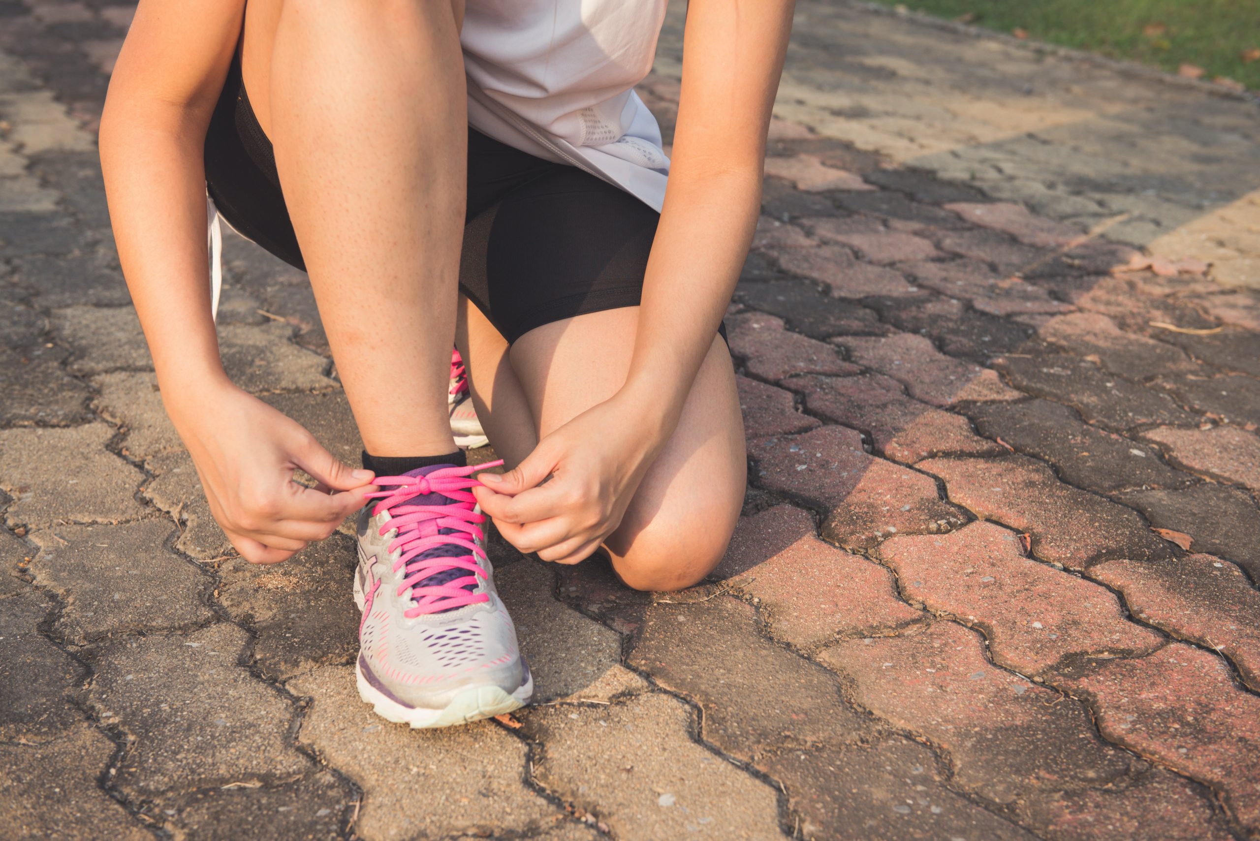 Person tying shoelaces before a run.